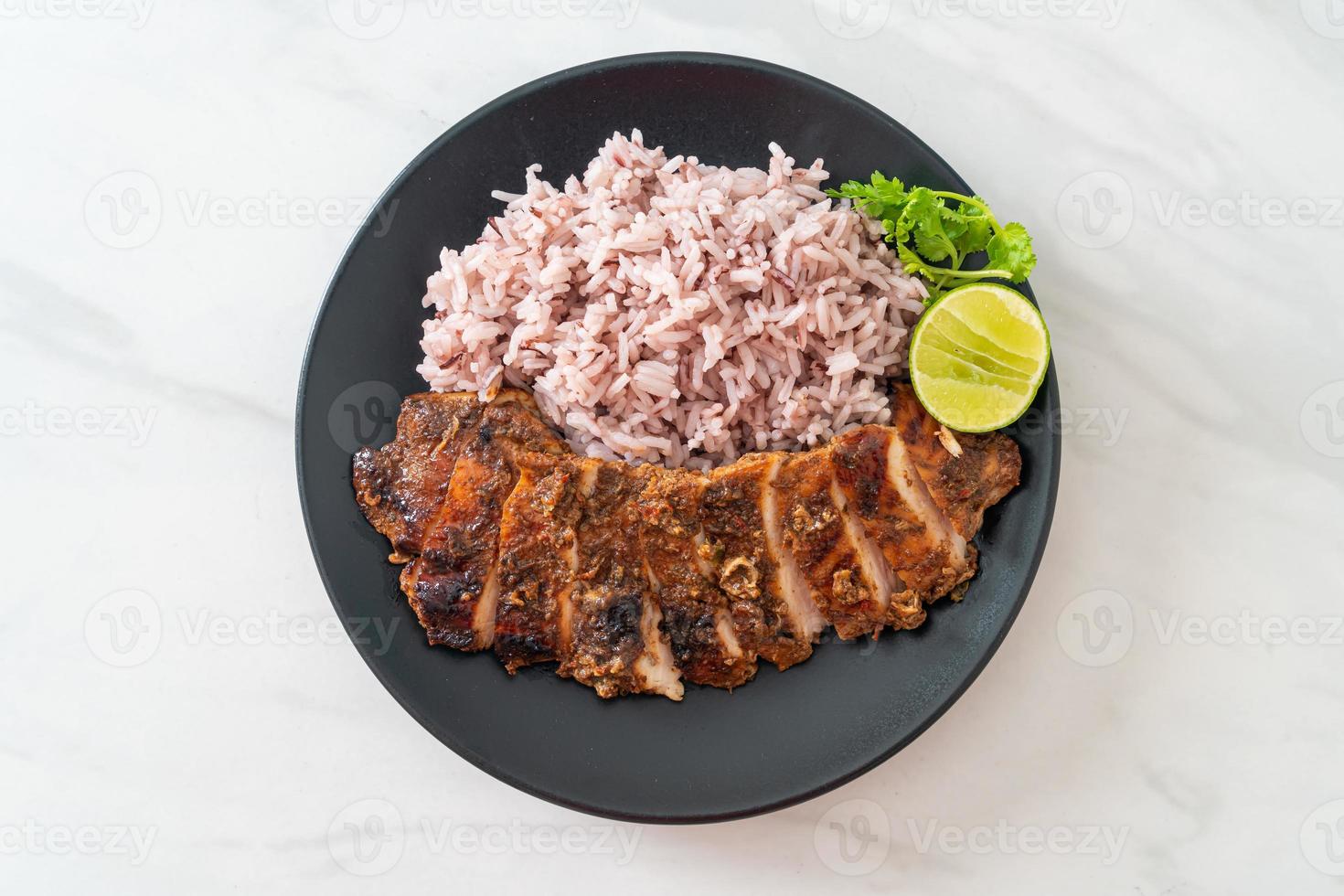 spicy grilled Jamaican jerk chicken with rice photo