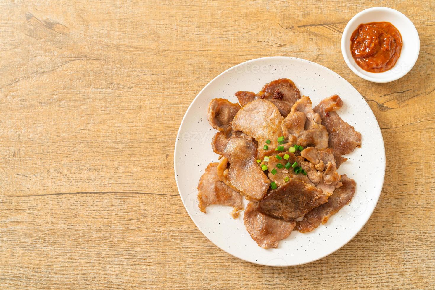 grilled pork neck sliced on plate photo