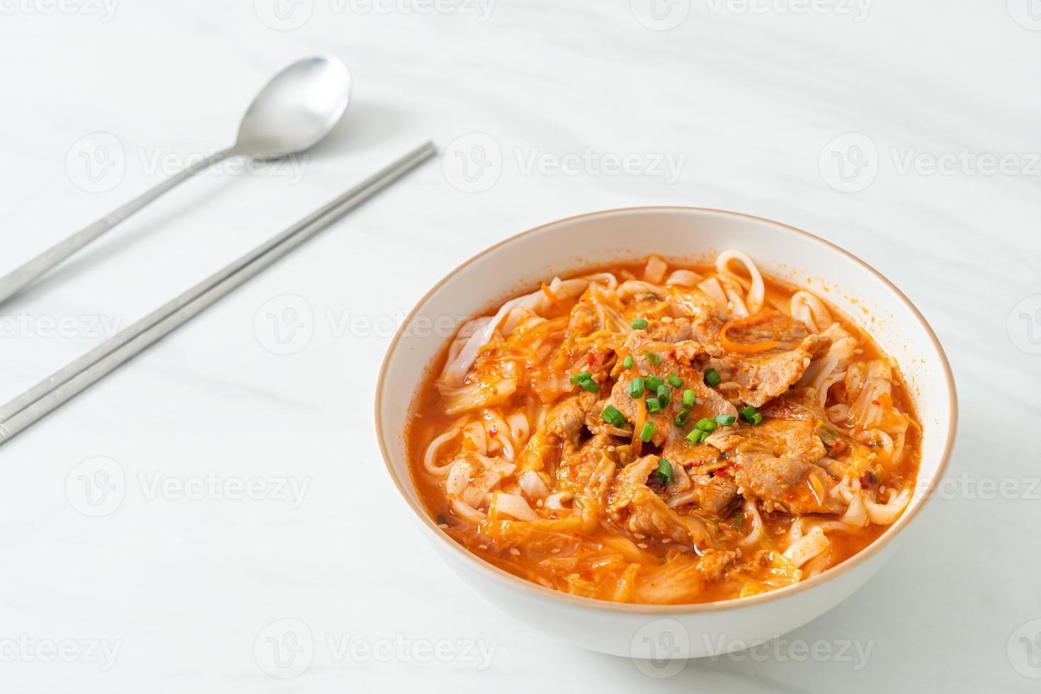 Korean udon ramen noodles with pork in kimchi soup photo