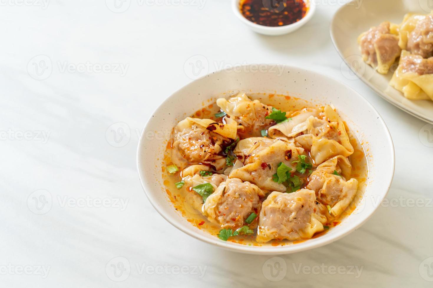 pork wonton soup or pork dumplings soup with roasted chili photo