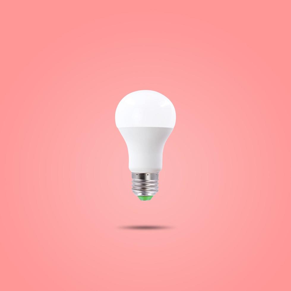 LED energy saving lamp 230v isolated on red pastel color background photo