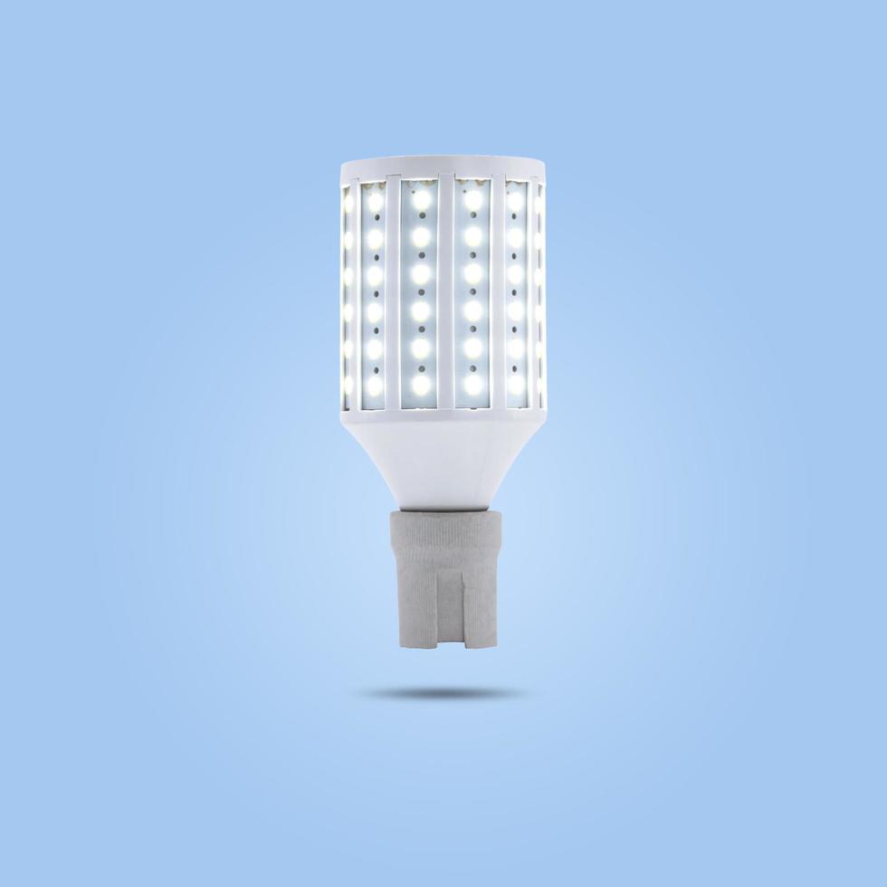 LED energy saving lamp 230v in a ceramic socket isolated on blue pastel color background. photo