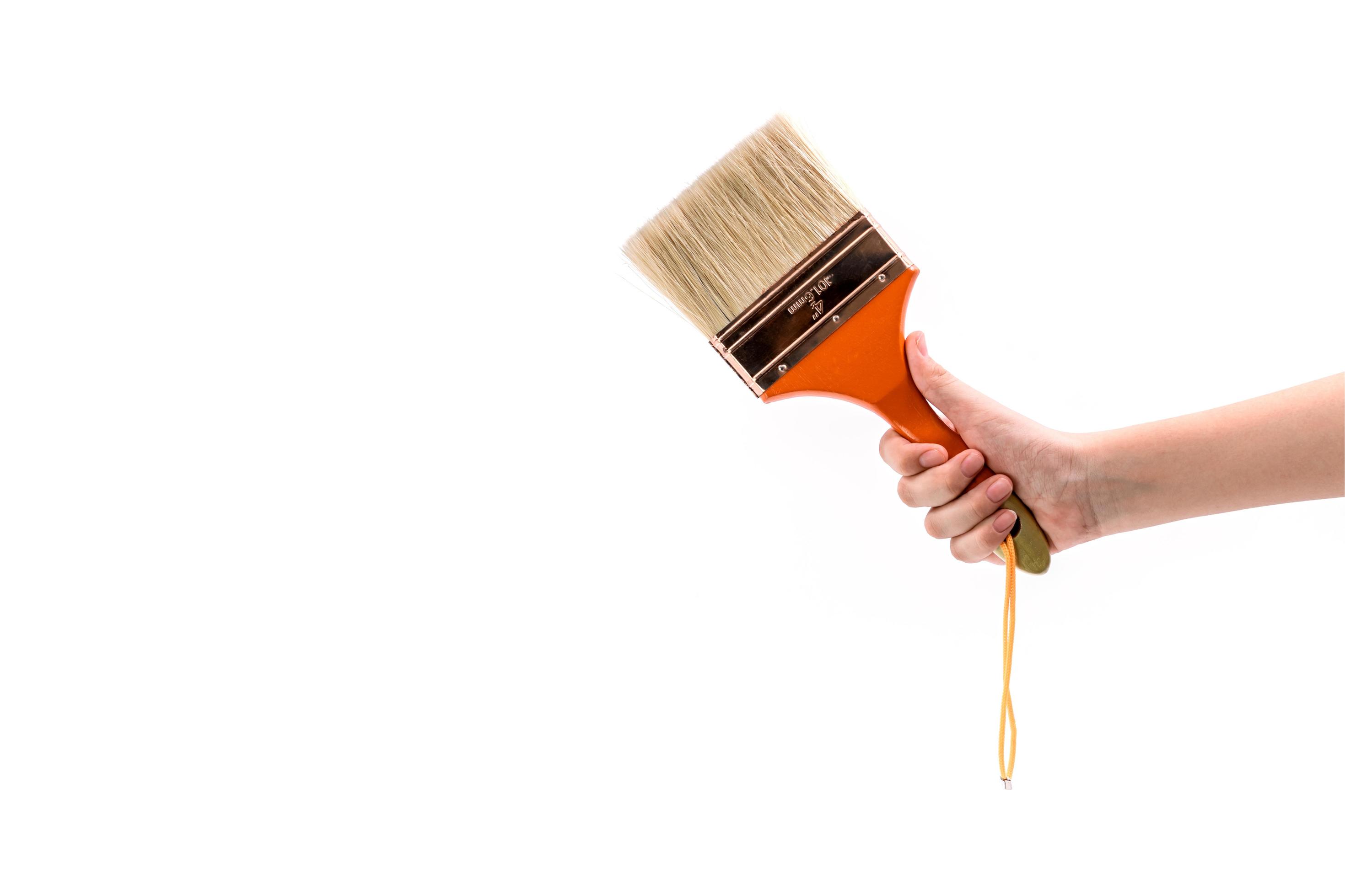 Hand Holding Big Paintbrush Isolated On White Stock Photo