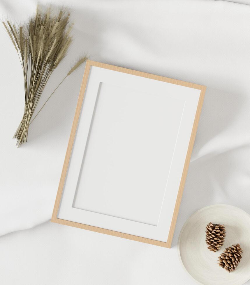 The picture frame was placed on a white cloth covered with dry grass and pine cones. photo