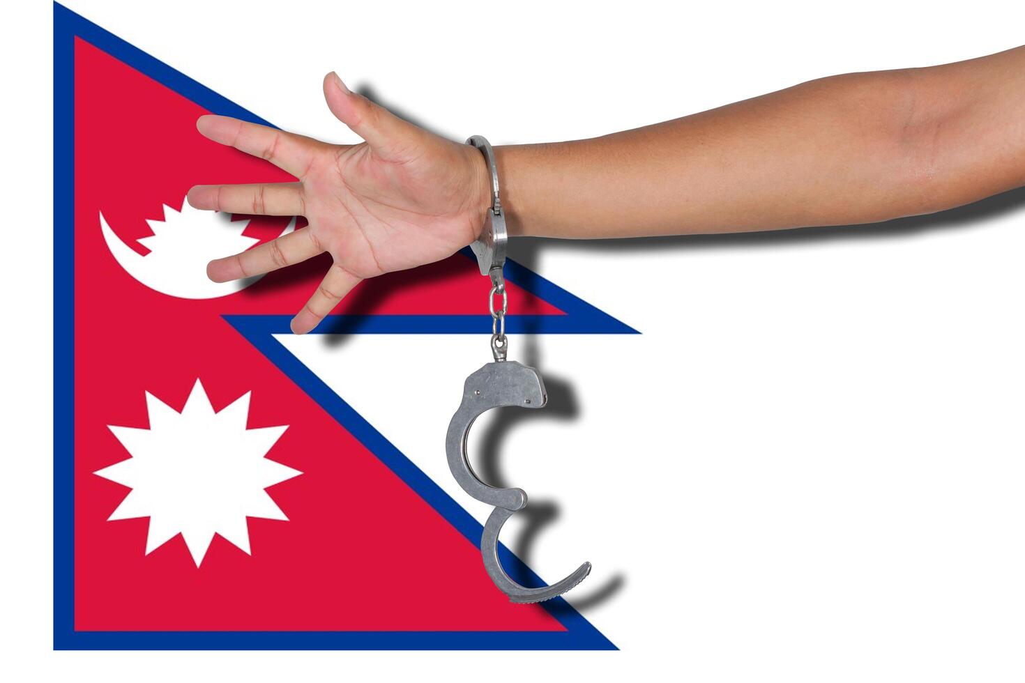 handcuffs with hand on Nepa flag photo