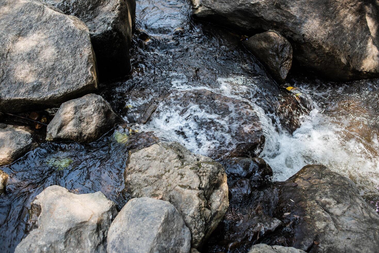 Waterfall in the nature and stone background photo