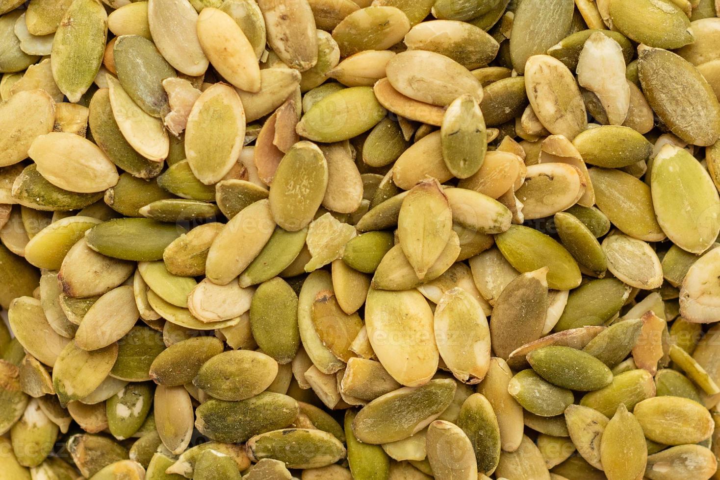 Pumpkin seeds close up. It can be used as a background photo