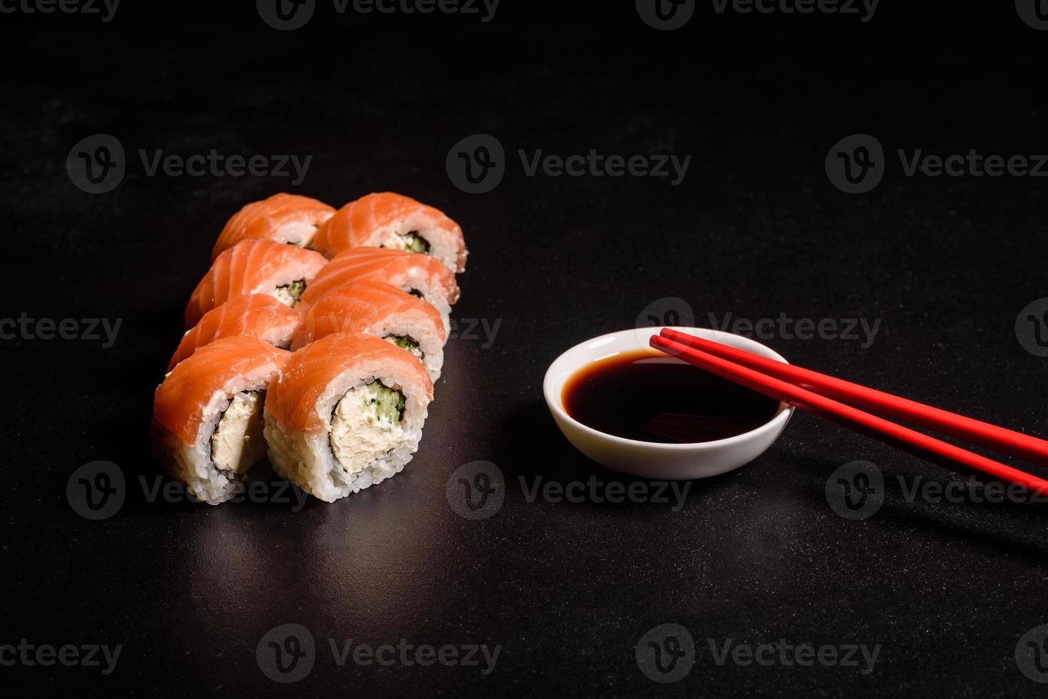 Various kinds of sushi served on a dark background photo