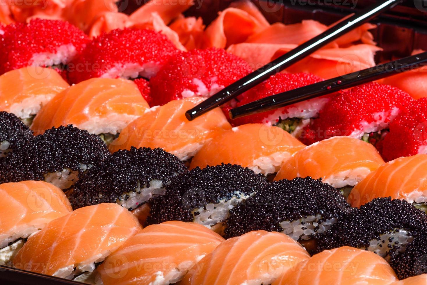 Various kinds of sushi served on a dark background photo