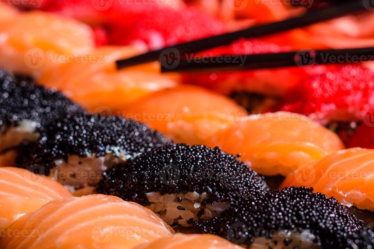 Various kinds of sushi served on a dark background photo