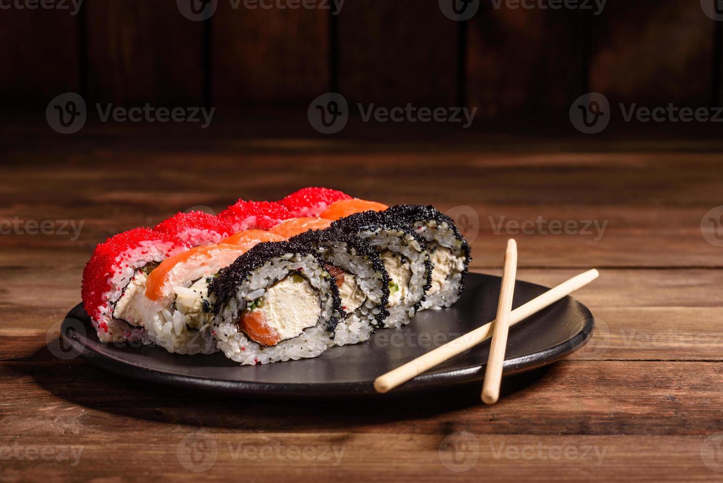 Various kinds of sushi served on a dark background photo