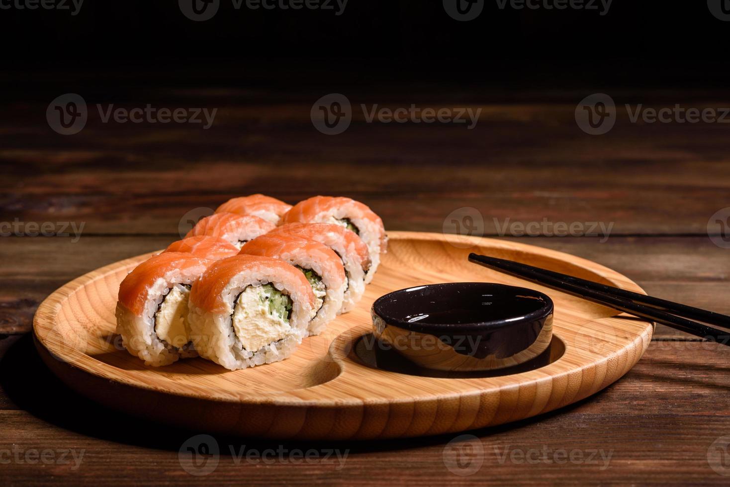 Various kinds of sushi served on a dark background photo