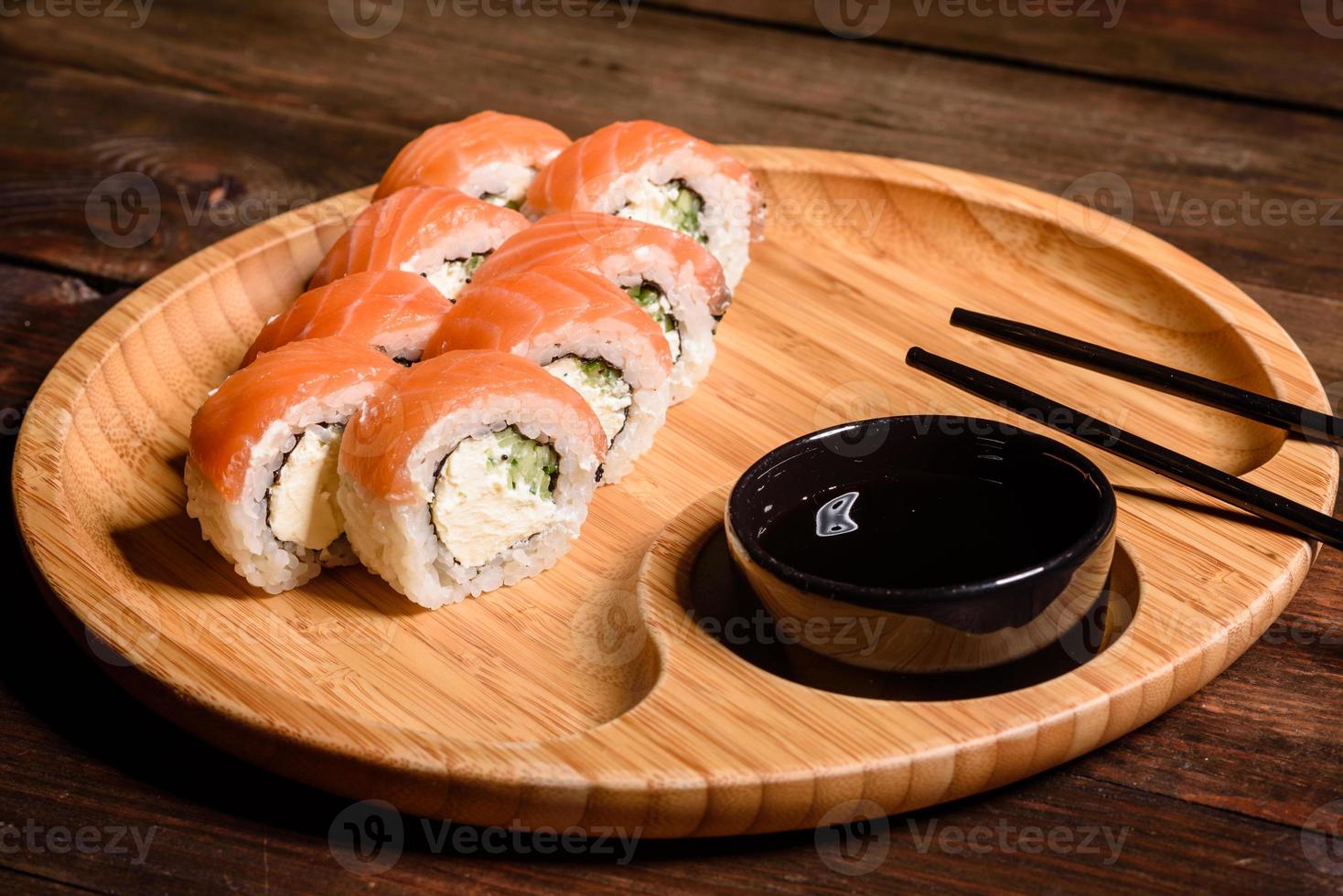 Various kinds of sushi served on a dark background photo