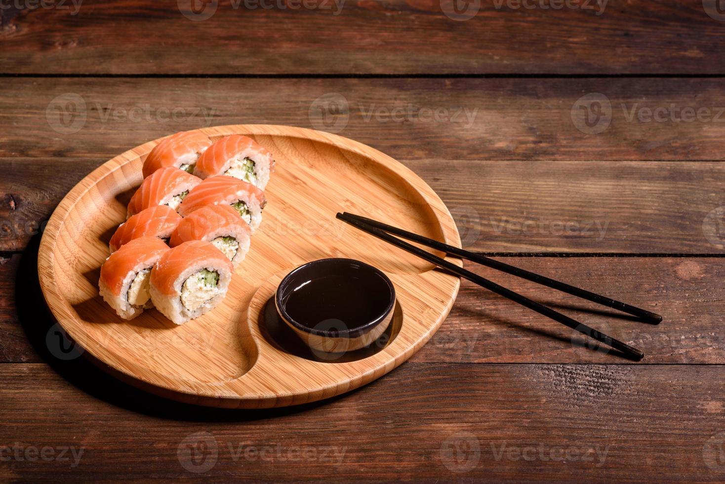 Various kinds of sushi served on a dark background photo