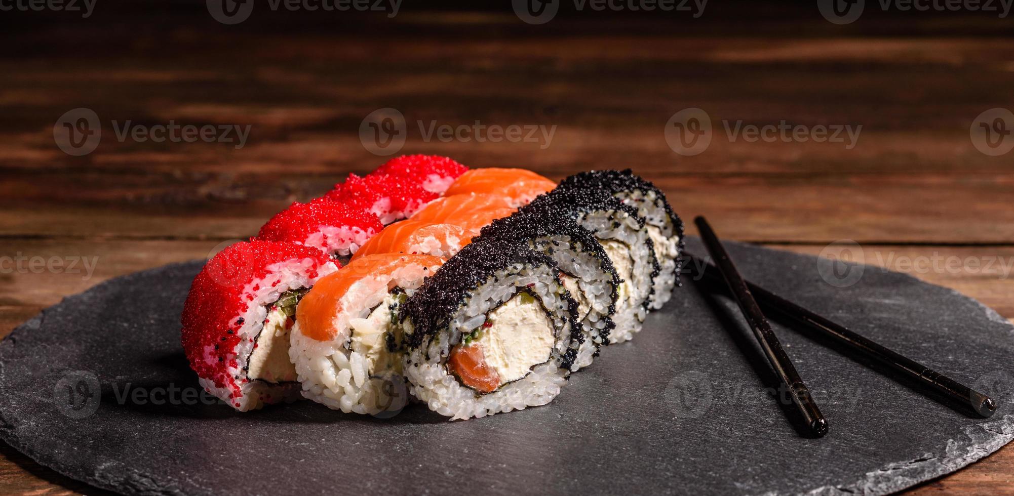 Various kinds of sushi served on a dark background photo