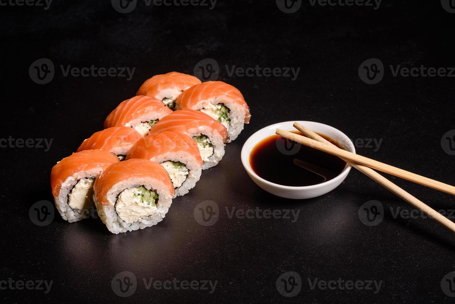 Various kinds of sushi served on a dark background photo