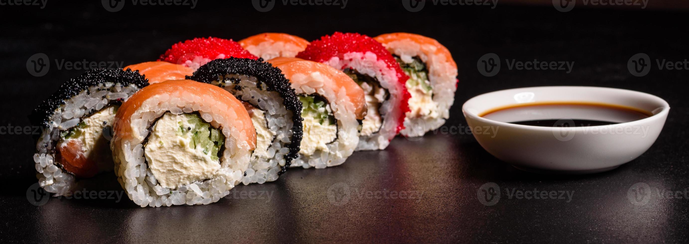 Various kinds of sushi served on a dark background photo