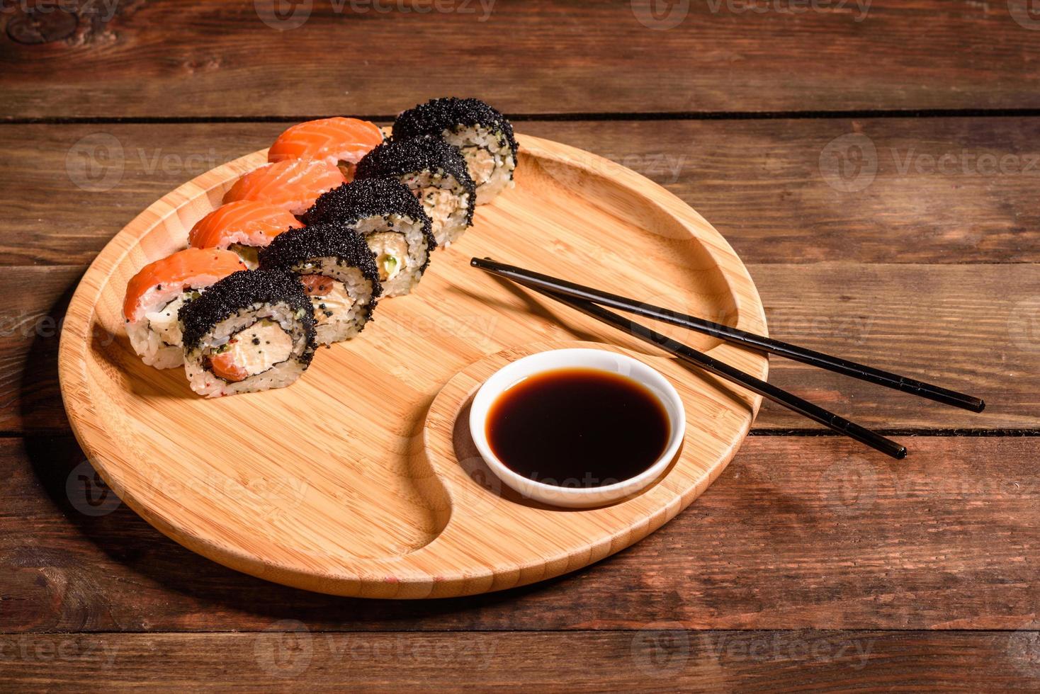 Various kinds of sushi served on a dark background photo