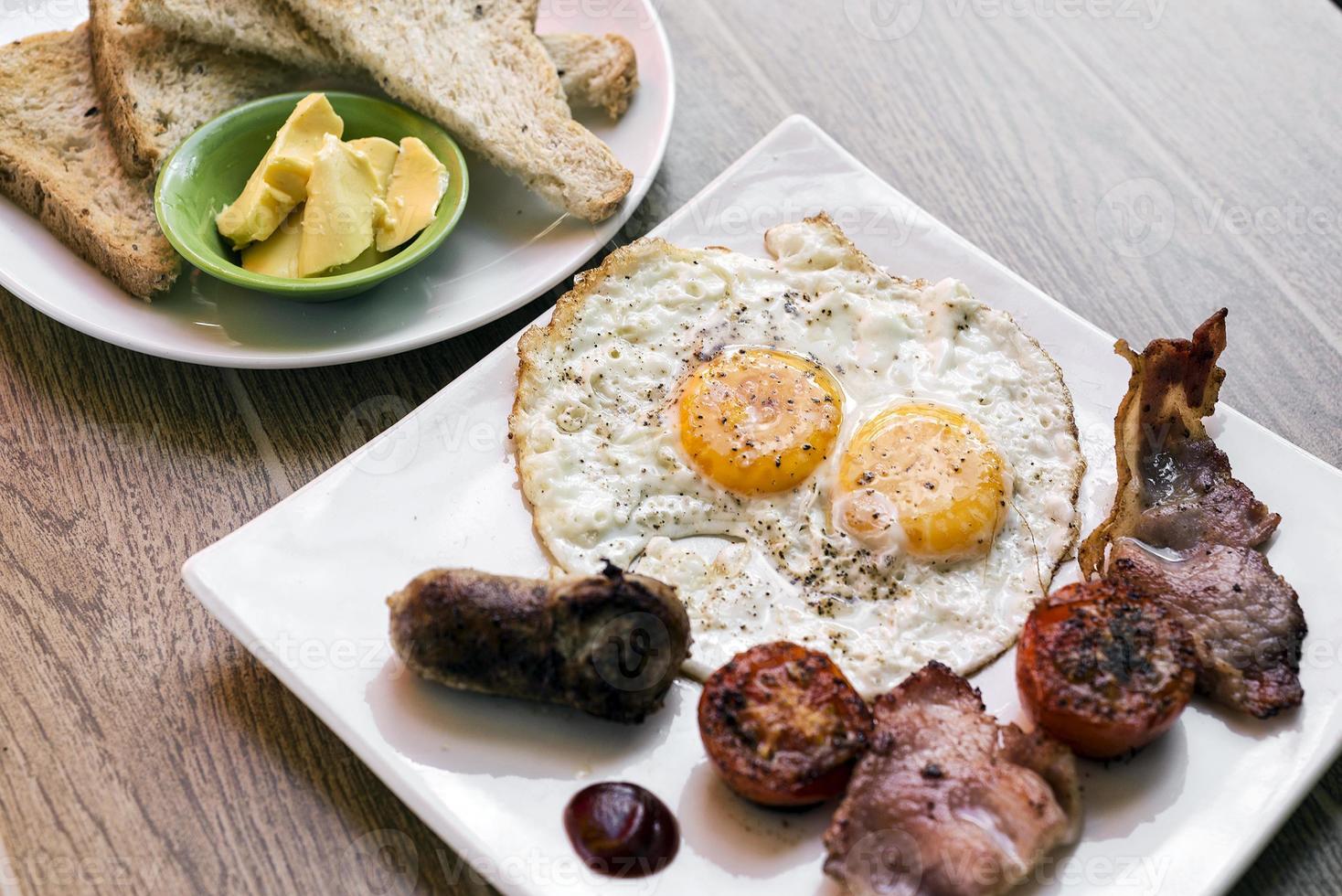 traditional english british fried breakfast with eggs bacon and sausage photo