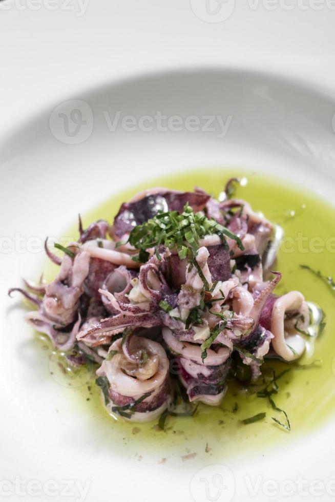 portuguese traditional fresh seafood marinated squid salad in coriander oil photo