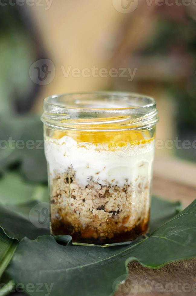 granola, coconut mousse, dates and turmeric powder healthy vegan dessert photo