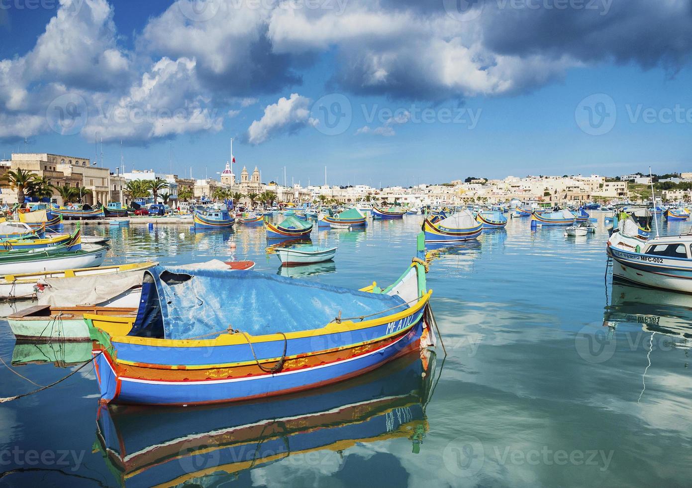 marsaxlokk harbour and traditional mediterranean fishing boats in malta photo