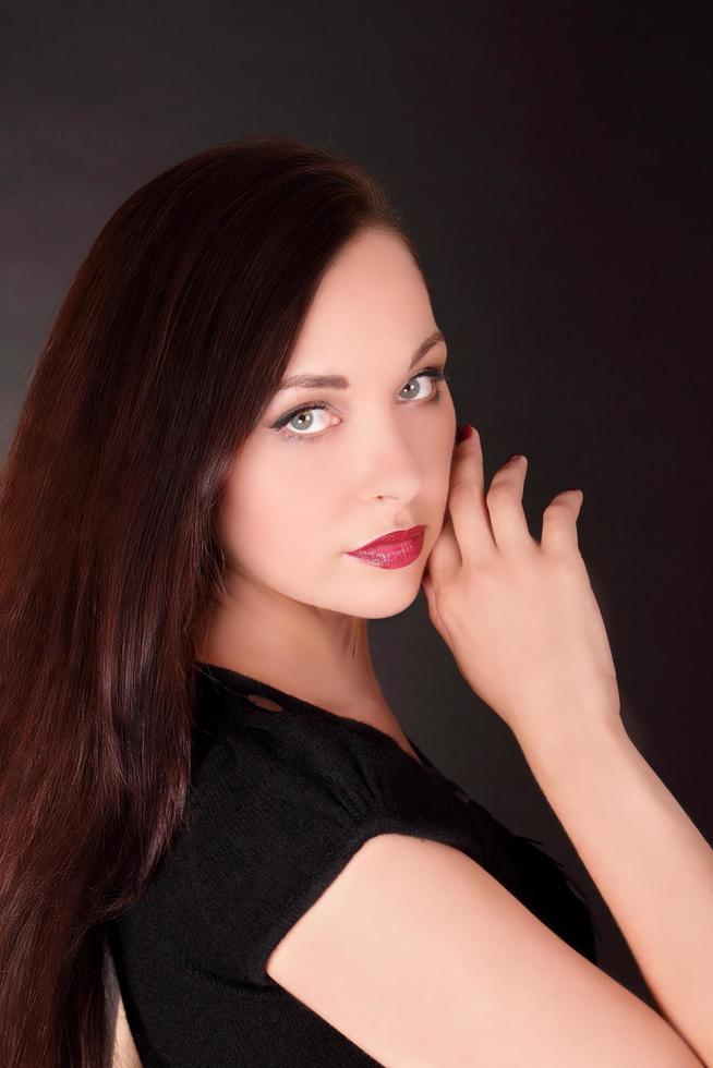 Young brunette woman with long hair, portrait of female model photo