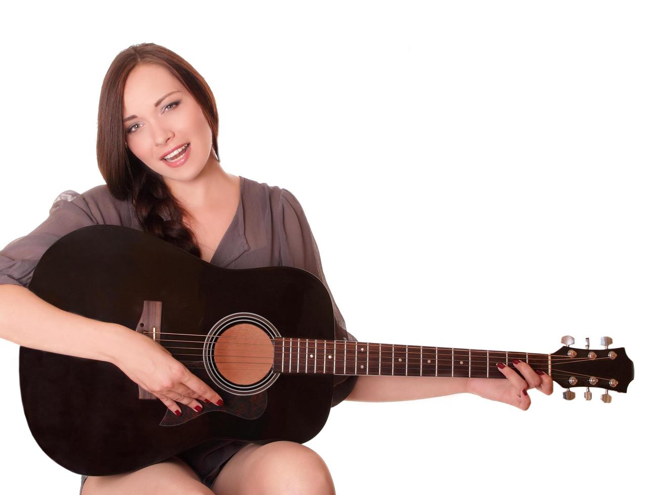 Beautiful young girl sitting with guitar photo