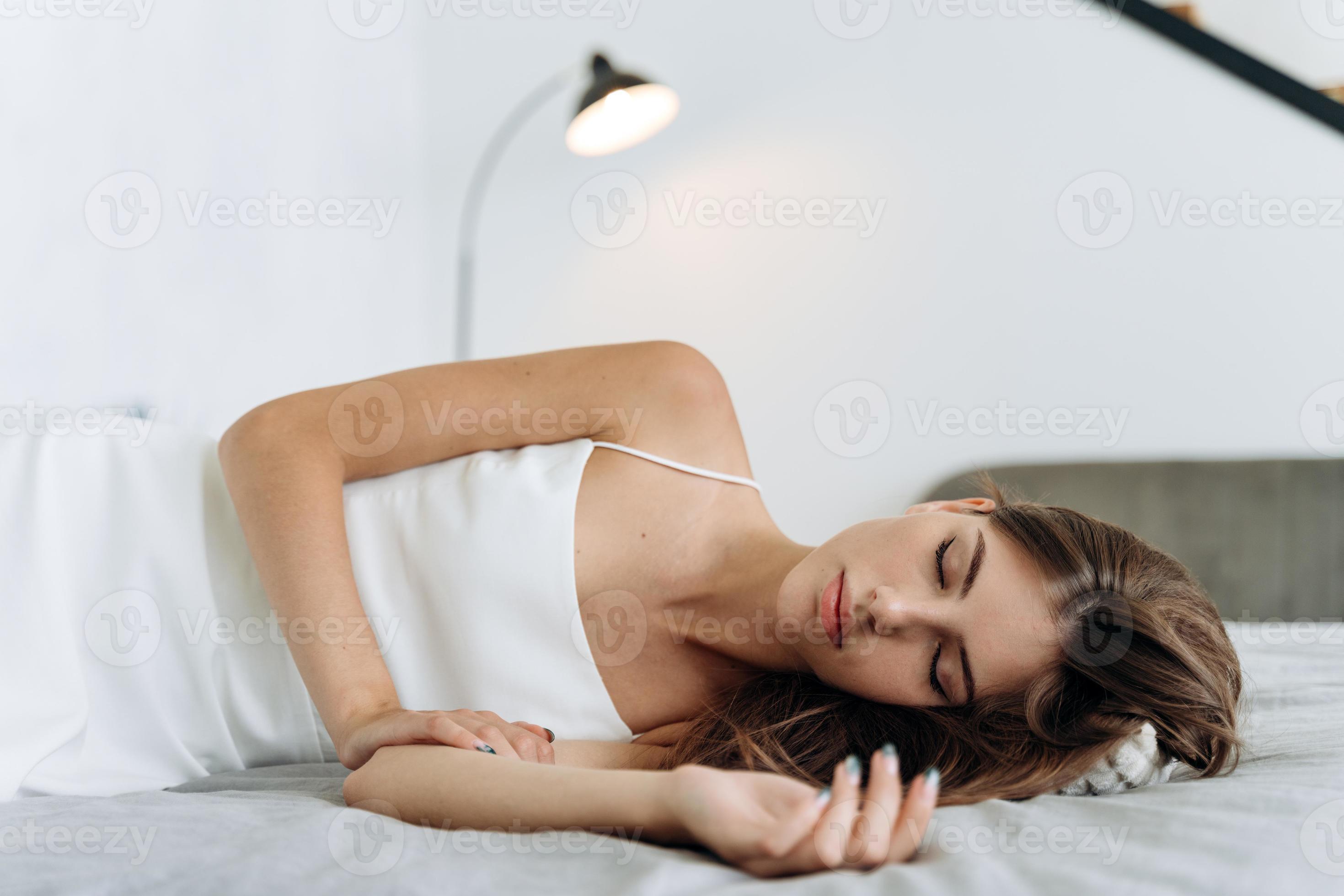 Woman sleeping. Beautiful young woman with long hair lying in the bed and  keeping eyes closed while sleeping at the morning. People lifestyle and  female appearance concept 3490271 Stock Photo at Vecteezy