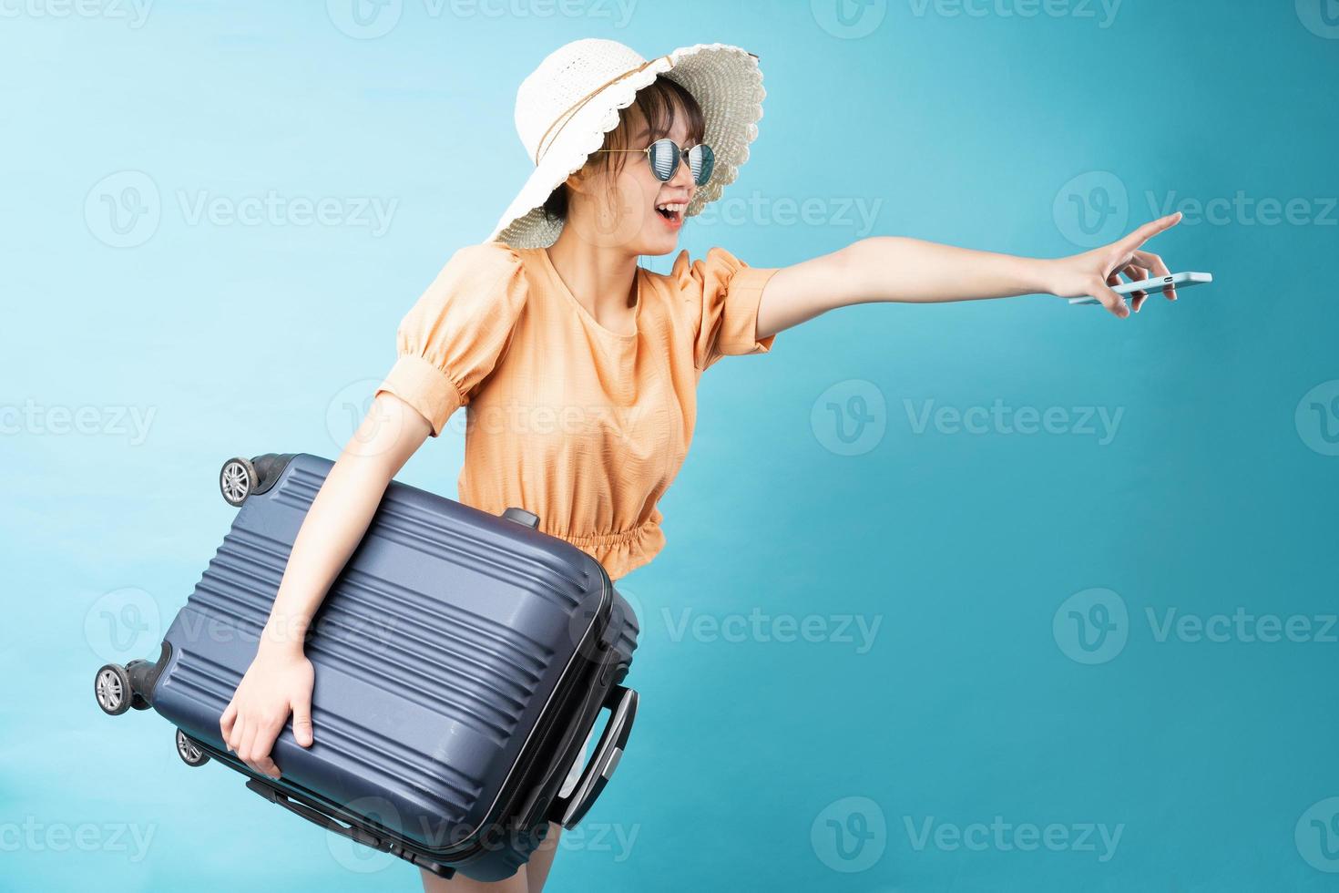 Portrait of young girl traveling on blue background photo