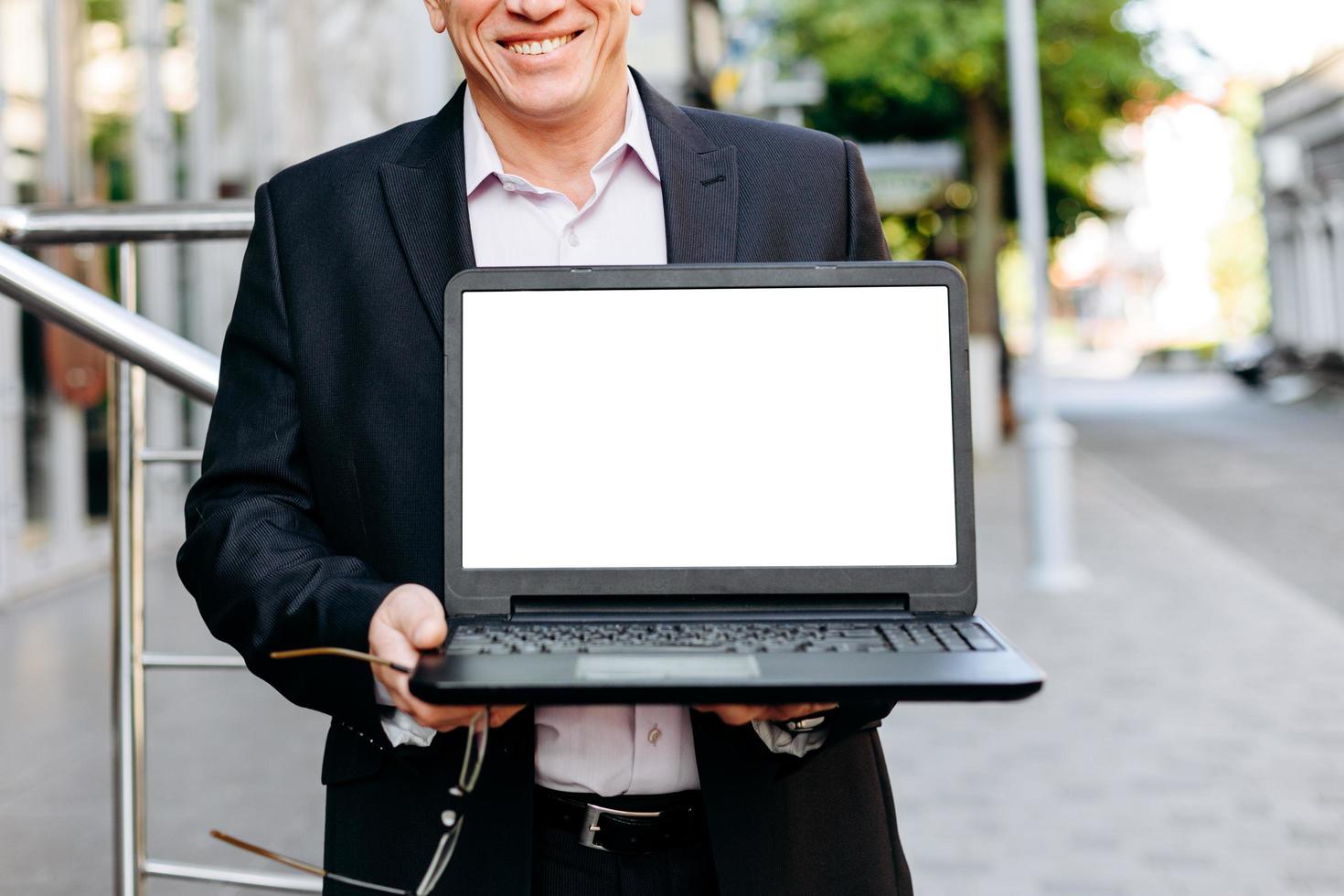Cropping image of businessman holding open laptop, empty white blank screen- Image photo