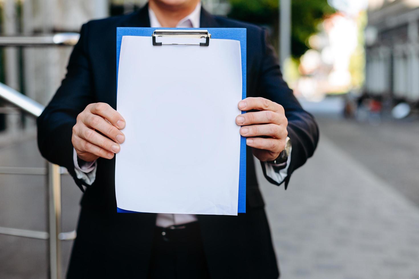 Closeup white empty blank mockup of paper sheet in  male hands  - Copy space photo