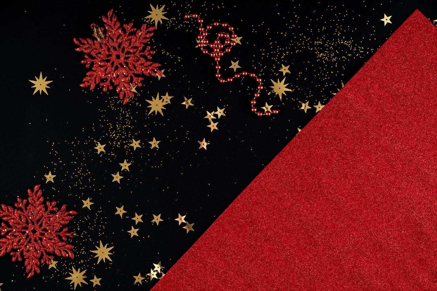 Festive red and black Christmas background with sequins and snowflakes photo