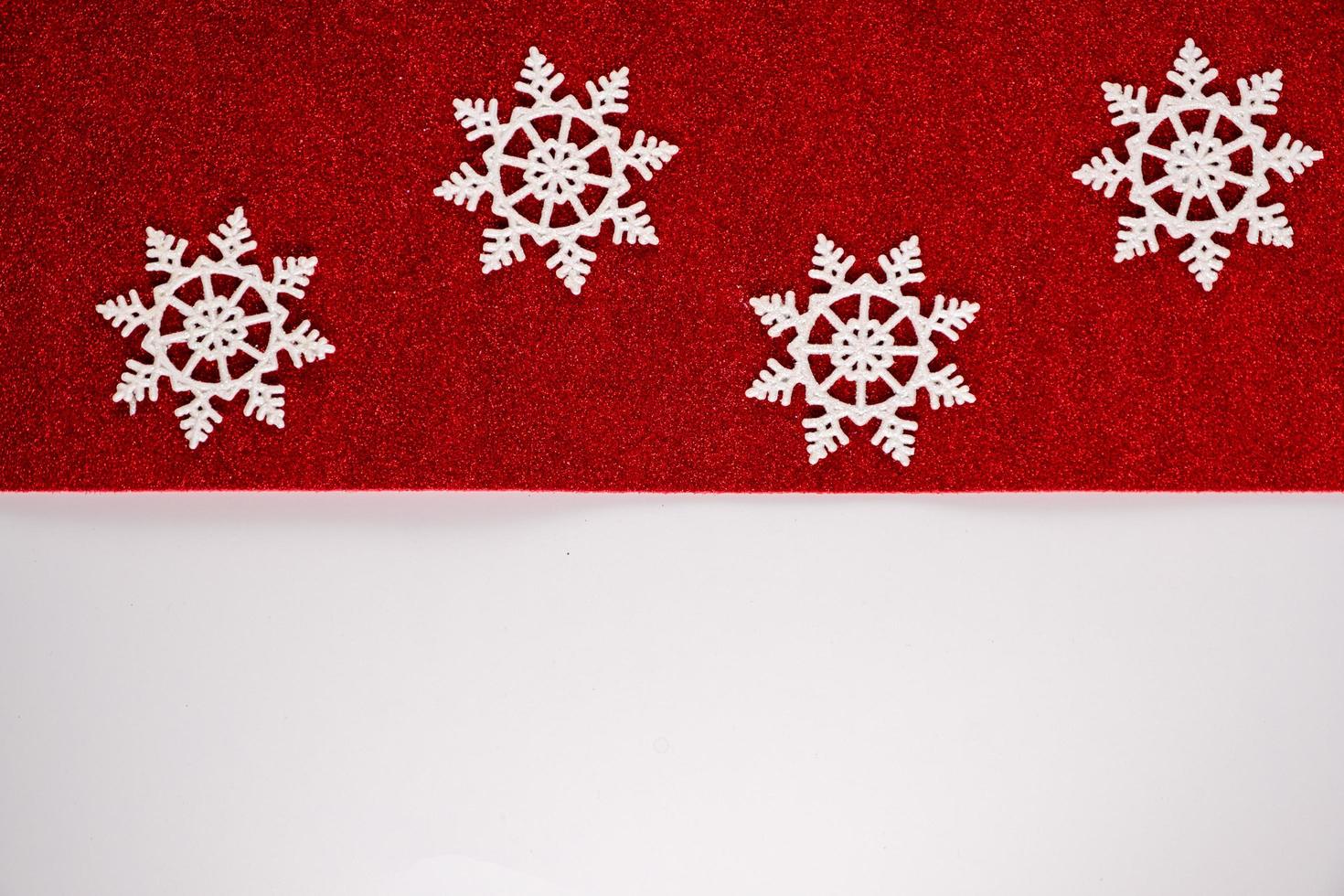 Classic red christmas ornaments decorations background with horizontal glitter snowflakes. photo