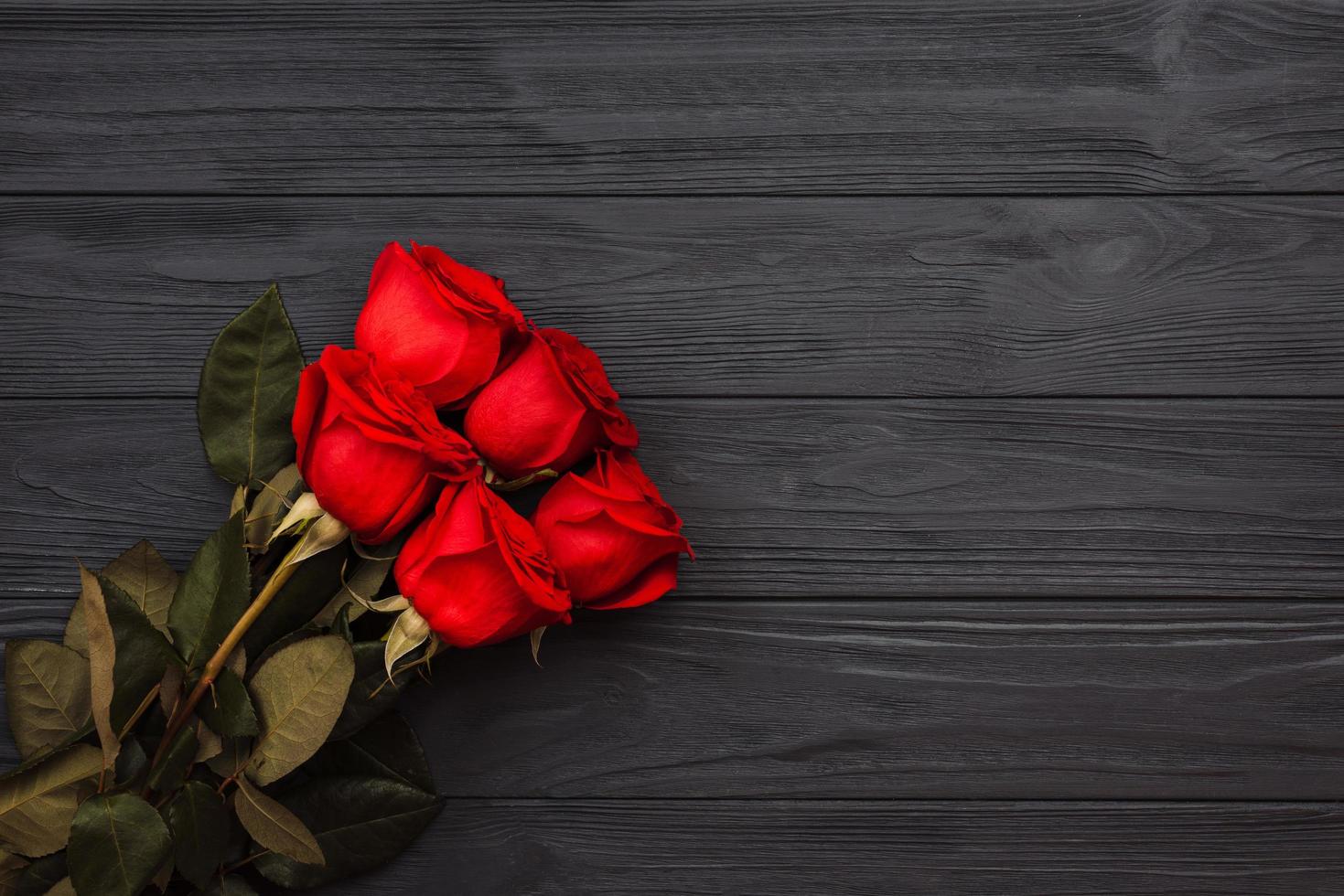 Bouquet of red roses on a dark wooden background. 3491566 Stock Photo