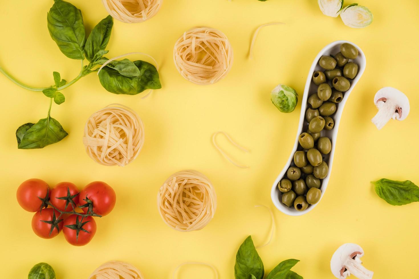 Pasta, basil, olives. Background of products. Top view. photo