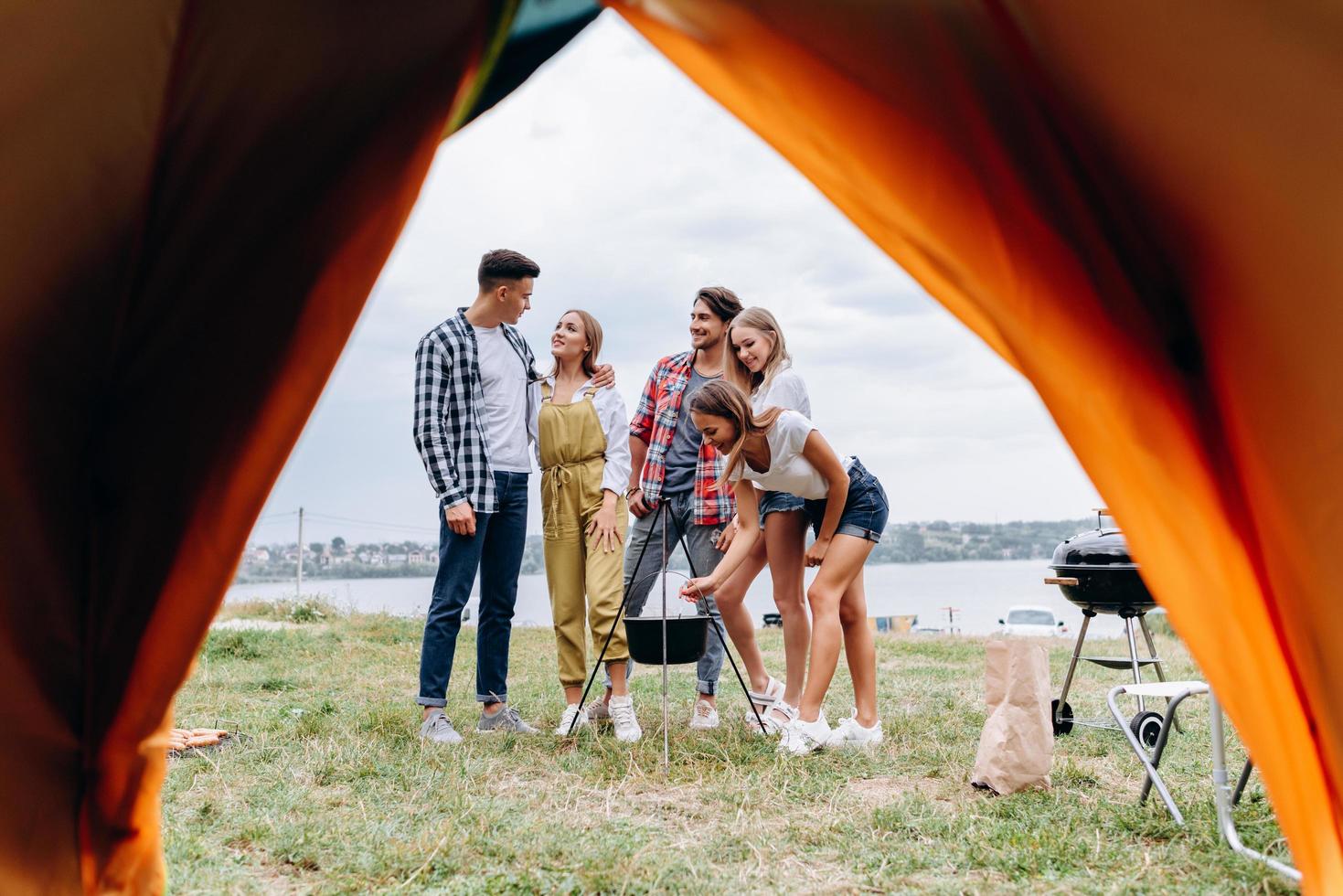 A company of friends have funny time  in the camping photo