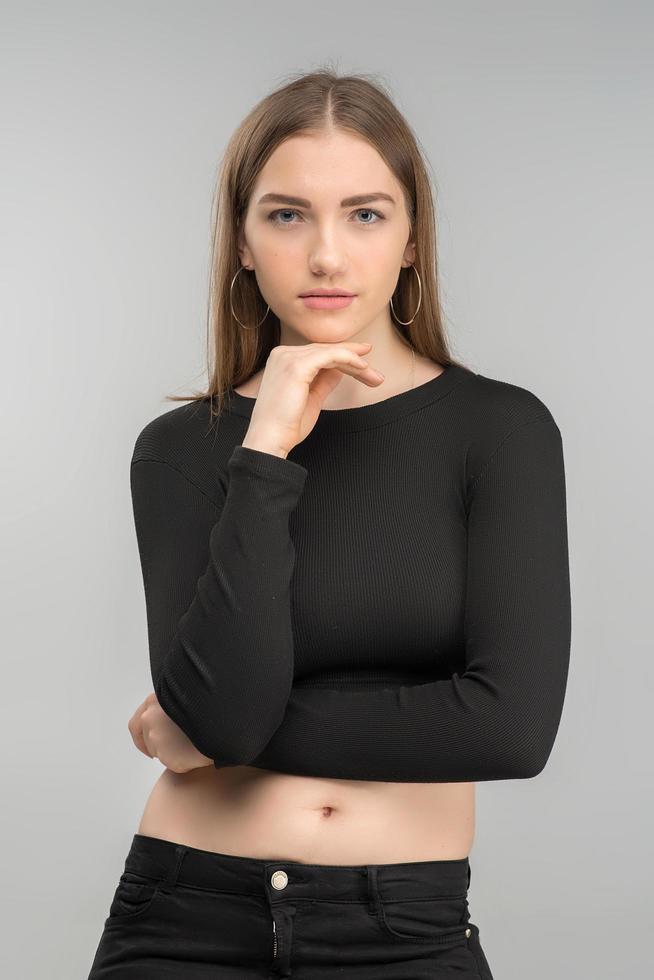 Portrait of serious beautiful blonde woman posing in black  top. - Vertical images photo