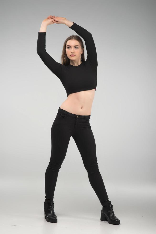 Full length portrait of sad woman in the black clothes with raised hands up - Image photo