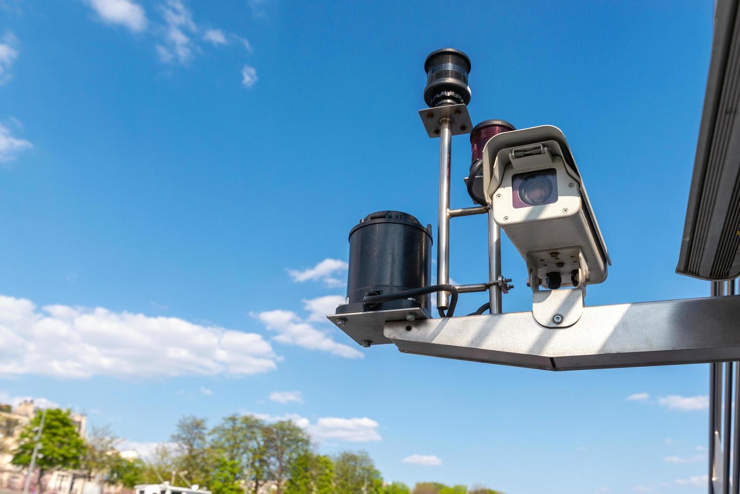 CCTV Security camera over blue sky background. - Image photo