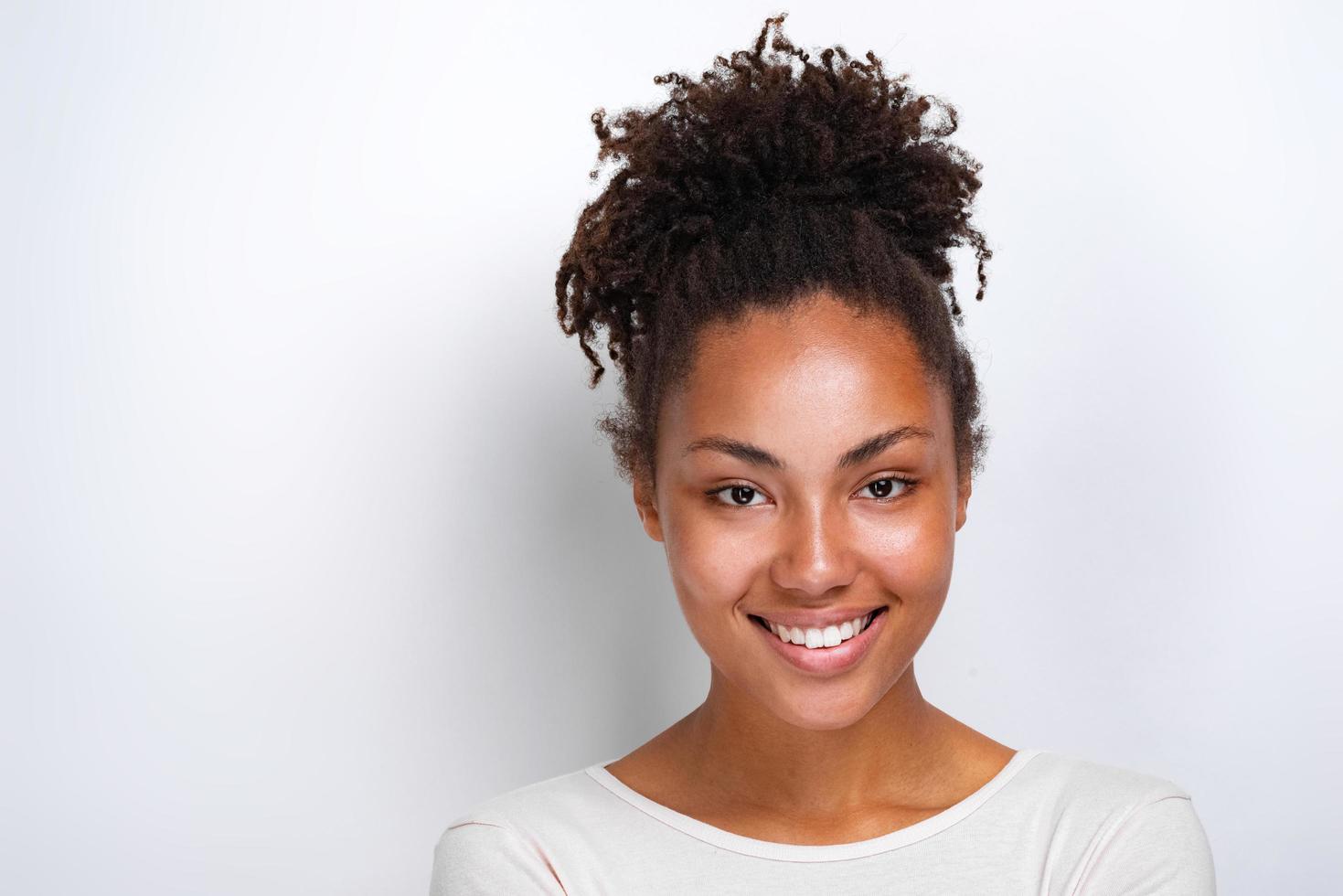 Closeup portrait of a charming girl over light studio background- Image photo