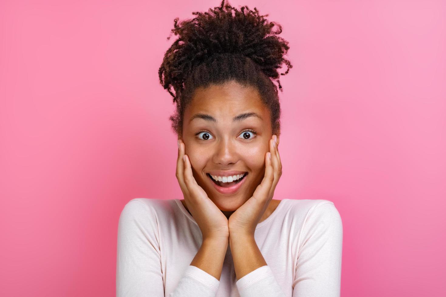 Closeup portrait of a pretty girl over pink background with amazed emotion on face - Image photo