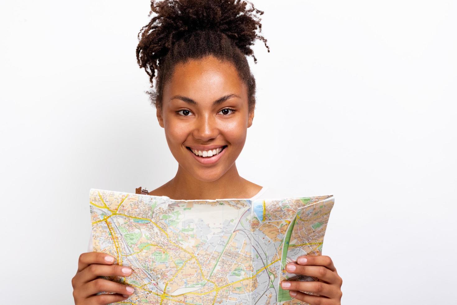 Close Up retrato de una niña feliz viajero con mapa en la mano y mirando a la cámara - imagen foto