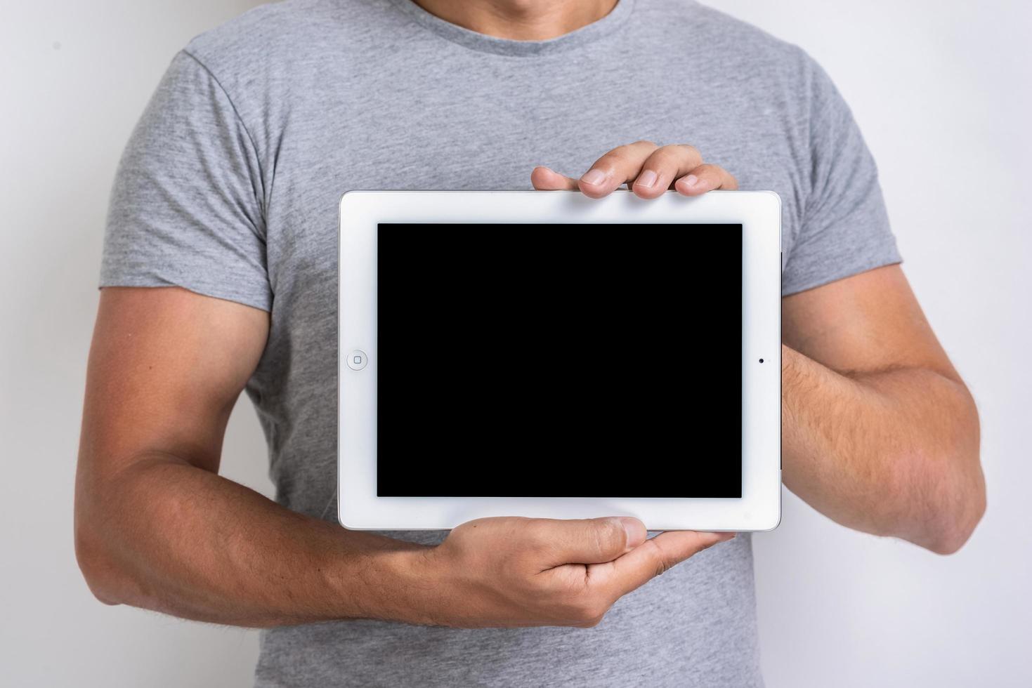 Mockup image of black empty blank screen of ipad in the male hands. - Image photo