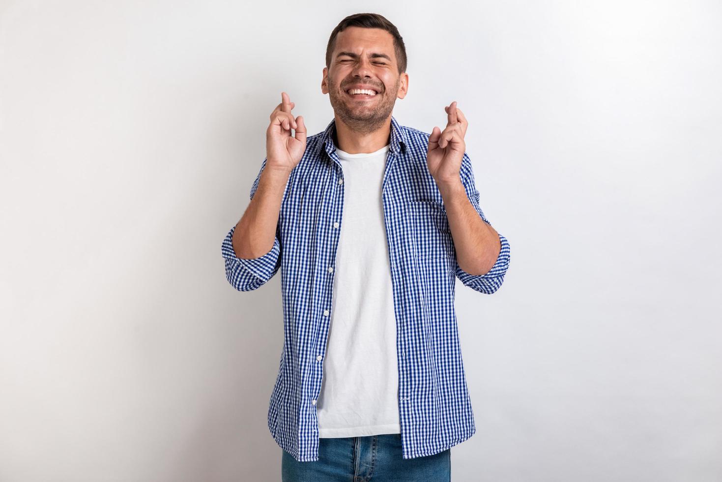 Man makes a gesture from crossing fingers in studio . - Concept dool luck gesture. - Image photo