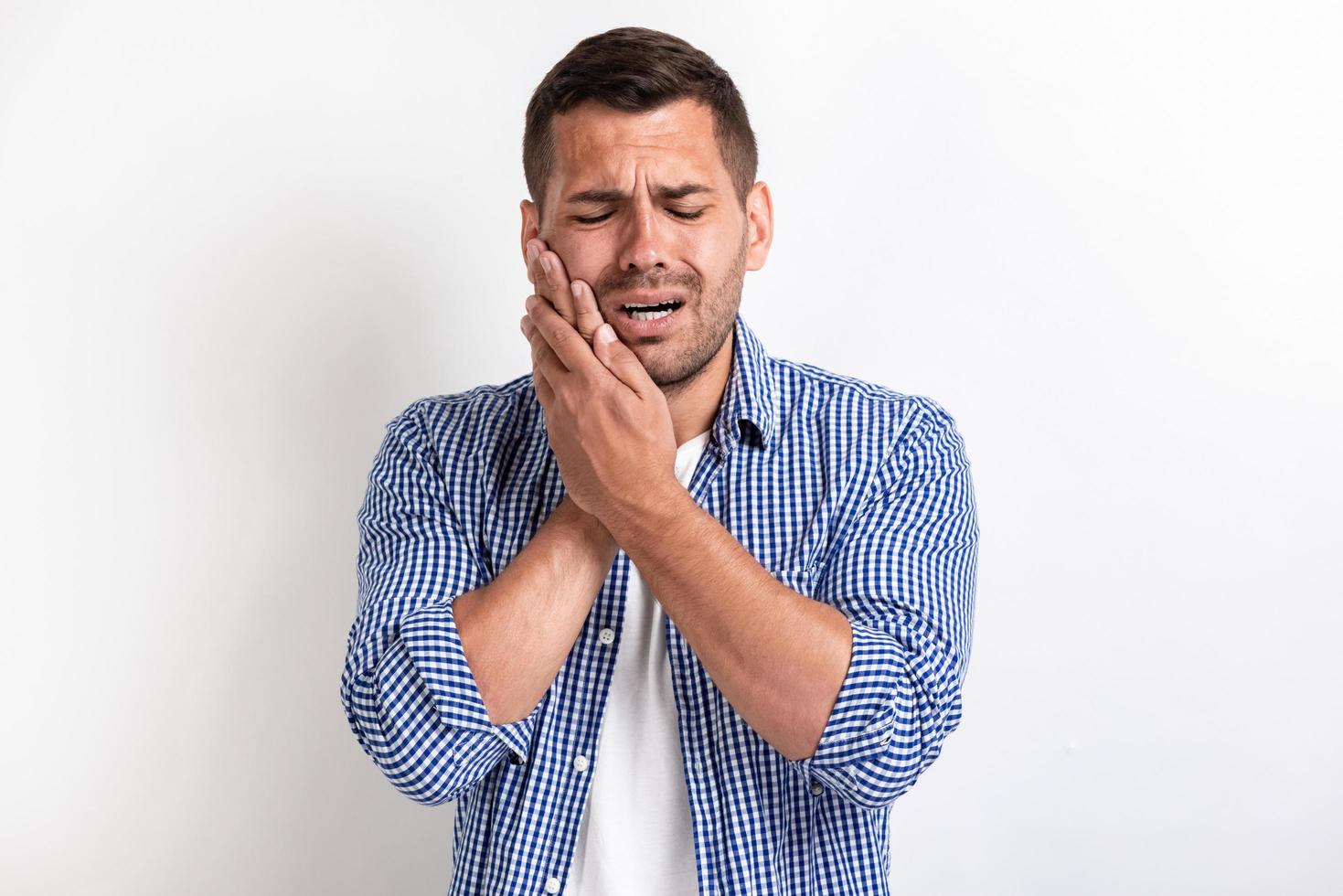 Image of sick man having a stomach ache and touched for his cheek photo