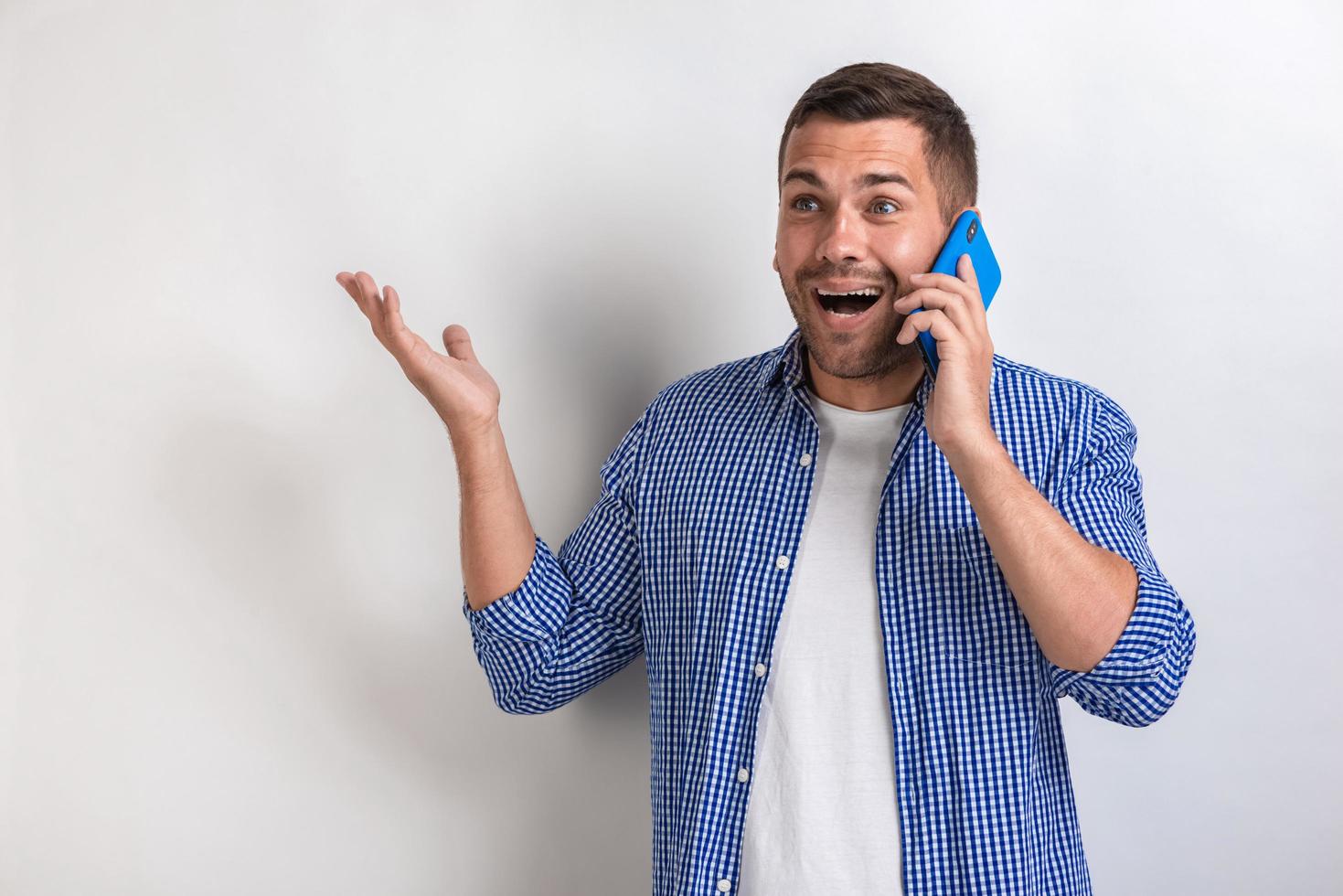 Closeup laughing very happy man talking to a smartphone and looking up .- Image photo