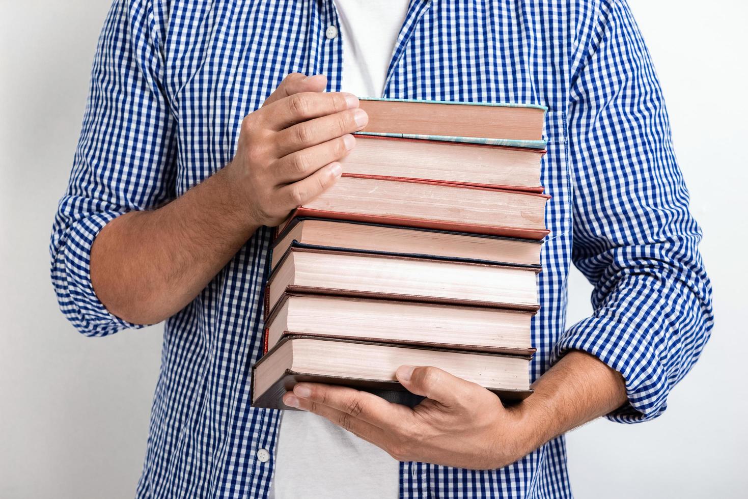 Closeup man holding books in his hands. Back to school.- Image photo