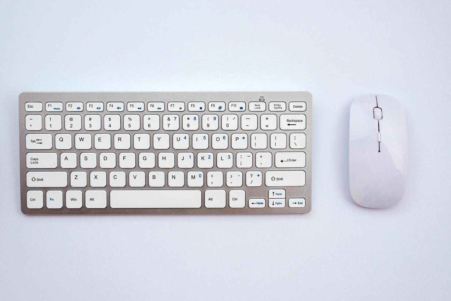 Top view office white  desk with a mouse and keyboard photo