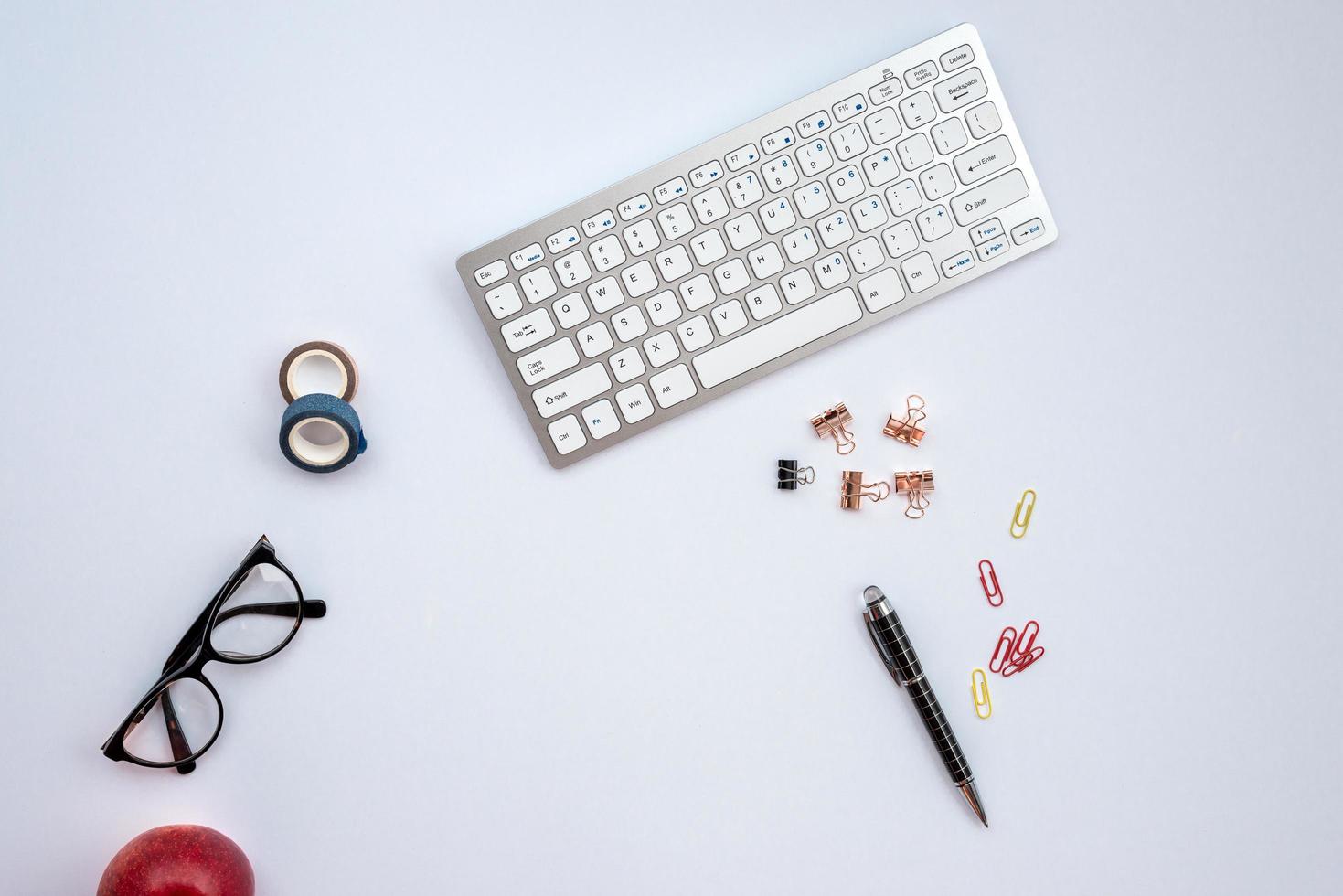 white desk with astationery and other objects on it photo